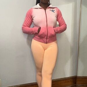 Pink and white zip up hoodie.